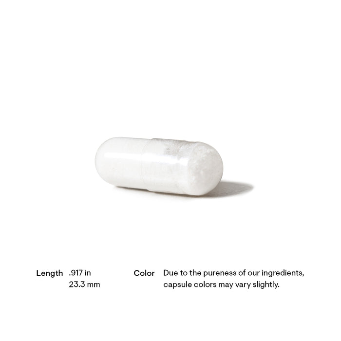 A white capsule pill is positioned against a plain background. Below it, text states its length as 0.917 inches (23.3 mm) and notes that the capsule color may vary due to ingredient purity.