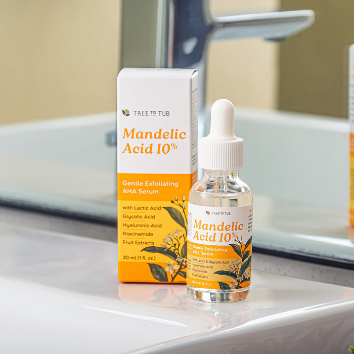 The Tree To Tub Mandelic Acid 10% Gentle Exfoliating AHA Serum is showcased on a bathroom countertop, highlighting ingredients such as lactic acid, glycolic acid, hyaluronic acid, niacinamide, and fruit extracts for a gentle exfoliation.