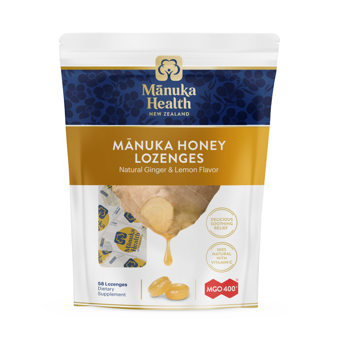 The Manuka Health pouch contains Manuka Honey Lozenges with natural ginger, lemon flavor, and Vitamin C. It features a honey dipper, mentions 58 lozenges as a dietary supplement, and indicates MGO 400+.