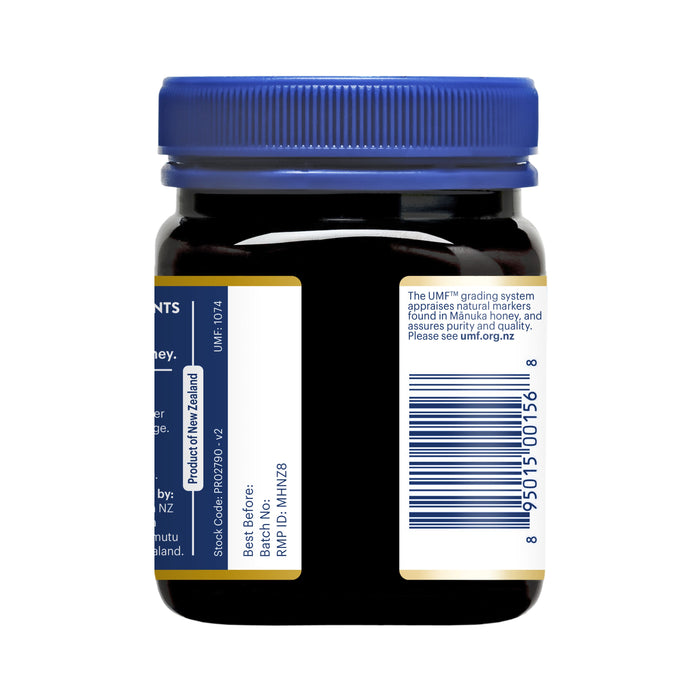 A dark jar with a blue twist-off lid features a partially visible label displaying product information, a barcode, and emphasizes its contents: Manuka Healths premium Manuka Honey MGO 573+ / UMF 16+.
