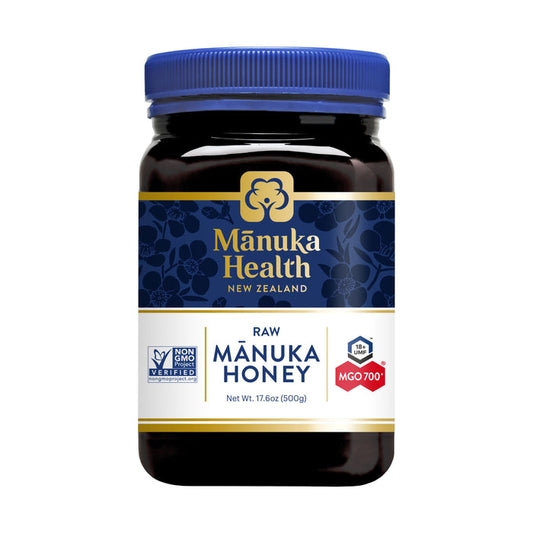 A 500g (17.6oz) jar of Manuka Healths non-GMO Manuka Honey, featuring a blue and gold floral label, boasts a UMF 18+ rating with MGO 700+, sourced from New Zealand.