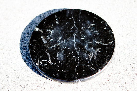 3.5 inch black marble display base for showcasing glass orbs and paperweights.
