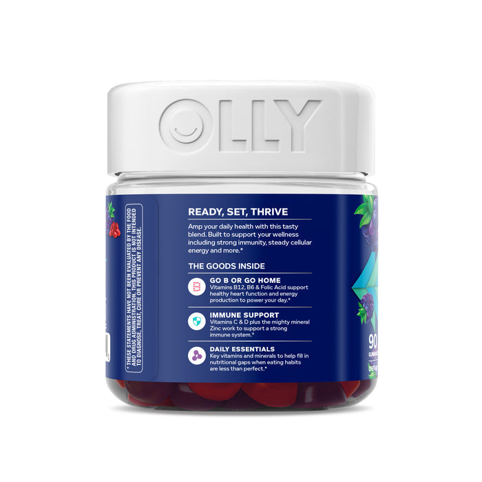 A jar of OLLY Mens Multi vitamins has a white lid, blue label with berry images, and highlights Ready, Set, Thrive and The Goods Inside, offering benefits like energy and immune support with CoQ10. It contains 90 gummies.