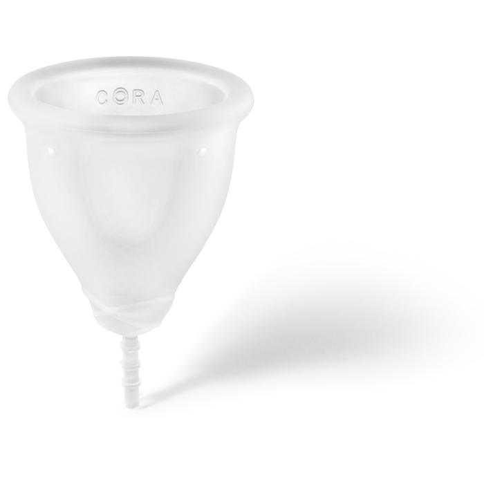 A Cora Menstrual Cup in white, embossed with Cora near the rim, features a smooth, rounded shape and small stem. The clean background and soft shadow highlight this eco-friendly period care product.