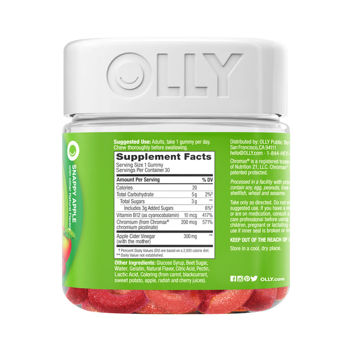 The clear jar with a white lid labeled OLLY contains red Metabolism Gummy Rings. The label features supplement and ingredient details. This Snappy Apple-flavored multivitamin, featuring Vitamin B12, supports adult health, and the jar holds 30 gummies.