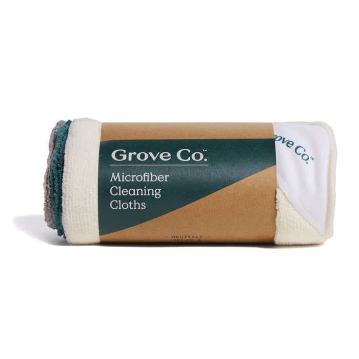 A set of three Grove Co. microfiber cleaning cloths offers eco-friendly appeal. The brown package with a teal label displays the brand and product name, while the white and teal cloth edges ensure sustainable, reusable cleaning options at your fingertips.