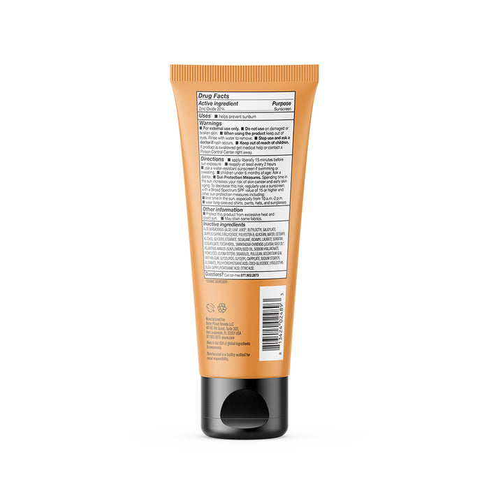 An orange tube of Acure Mineral Sunscreen - SPF 50 with a black flip-top cap is shown from the back, displaying drug facts, active ingredients, directions, and other details in small black text on a white label.