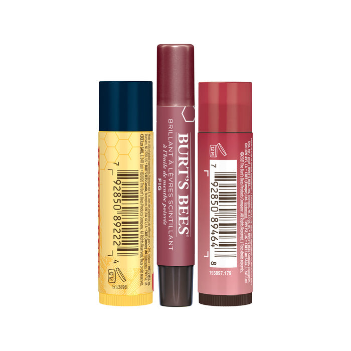 The Mistletoe Kiss Gift features three lip balm sticks: a blue and yellow one, a maroon Burts Bees, and a pink Tinted Lip Balm. Each has a barcode on its side against a white background.