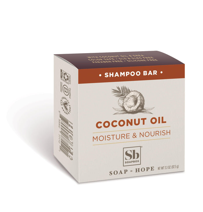 Image of a beige Soapbox Moisturizing Coconut Oil Shampoo Bar featuring a brown top and coconut illustration. Promoting eco-friendly hair care, the packaging highlights Moisture & Nourish, emphasizing its moisturizing ingredients.