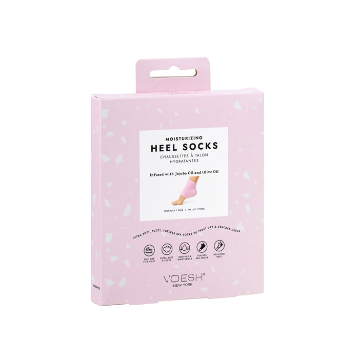 VOESH New Yorks Moisturizing Heel Socks come in elegant pink packaging and are infused with jojoba and olive oils. The angled display emphasizes their benefits for dry, cracked feet, ensuring a luxuriously soft experience.