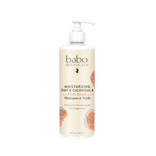 A 16 fl oz Babo Botanicals Moisturizing Shampoo & Wash offers a soothing, plant-based cleanse. The label features tan text and floral graphics on white, highlighting its calendula formula for gentle skin moisturization.