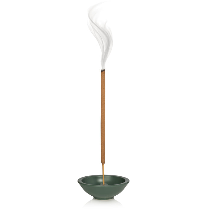 A lit Murphys Naturals Mosquito Repellent Incense Stick, infused with naturally derived oils, emits smoke from a green holder against a plain white background.