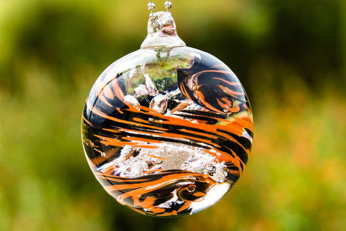 Black and orange motorcycle themed memorial orb infused with loved one's ashes