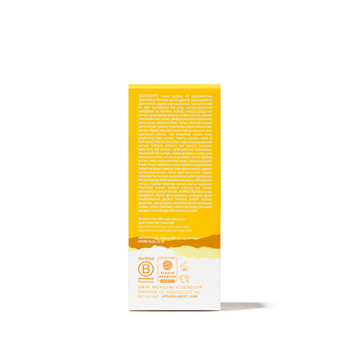 The back of a yellow and white Ursa Major Mountain Glow Serum box displays ingredients and product info. Certification logos, a recycling message, and text in white and orange are visible near the bottom.