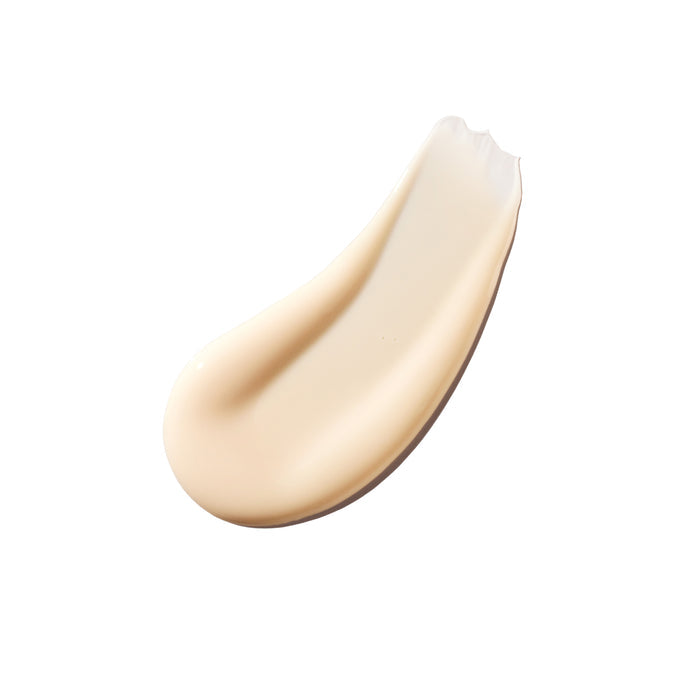 A smooth, creamy beige swatch of Ursa Major’s Mountain Glow Serum on a white background, perfect for enhancing skin nutrition.