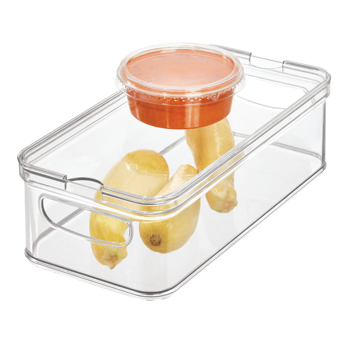 The iDesign Multi-Purpose Divided Bin is made with BPA-free, recycled plastic and is perfect as a refrigerator bin. It holds a small cup of red sauce and three yellow squash, featuring a lid with secure side handles for fresh storage and easy organization.