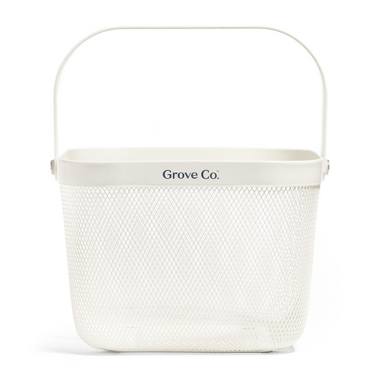 White rectangular metal caddy with mesh wire design and top handle, labeled Grove Co. Product name: Multi-Purpose Mesh Basket.