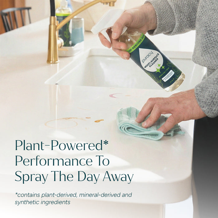 Person cleaning a white kitchen counter with Multi-Surface Cleaner Spray; text overlay near sink. #common