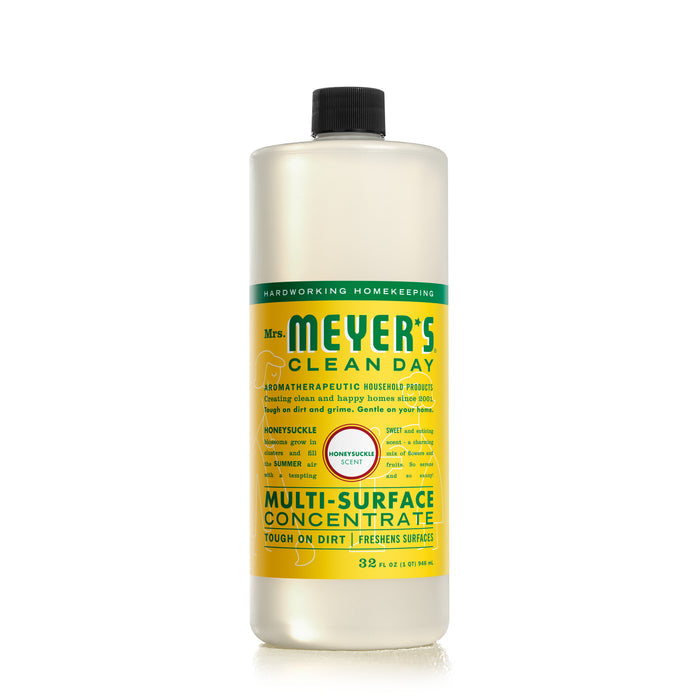 Mrs. Meyers Multi-Surface Concentrate, Honeysuckle scent, comes in a 32 oz bottle. Infused with essential oils, its yellow and green label boasts Tough on Dirt, Freshens Surfaces, highlighting its aromatherapeutic and powerful cleaning qualities.
