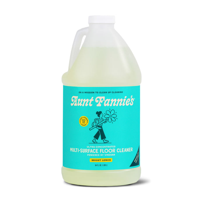 Aunt Fannies Multi-Surface Floor Cleaner, Bulk, features a turquoise label with a vintage illustration and text that reads Ultra-concentrated, powered by vinegar. This hypoallergenic, plant-based cleaner offers a refreshing lemon scent.