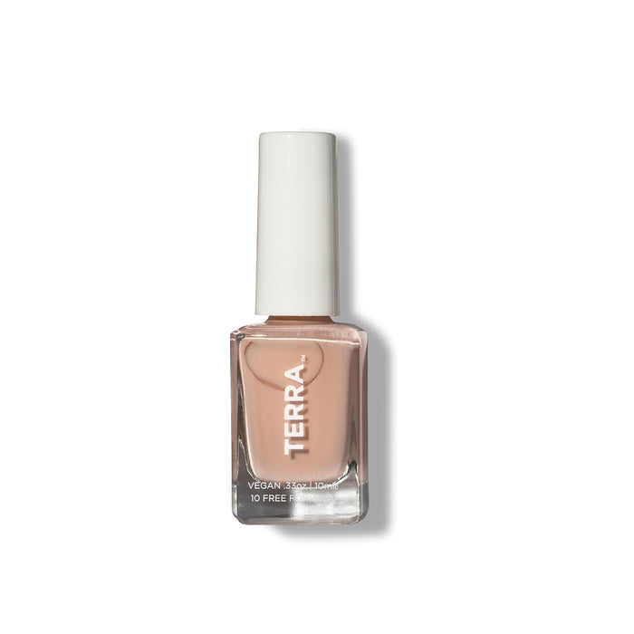 A bottle of nude nail polish from Terra Beauty Bars, featuring a chic white cap, highlights its vegan and 10-free formula. This cruelty-free product stands against a plain white backdrop, underscoring its dedication to conscious beauty.