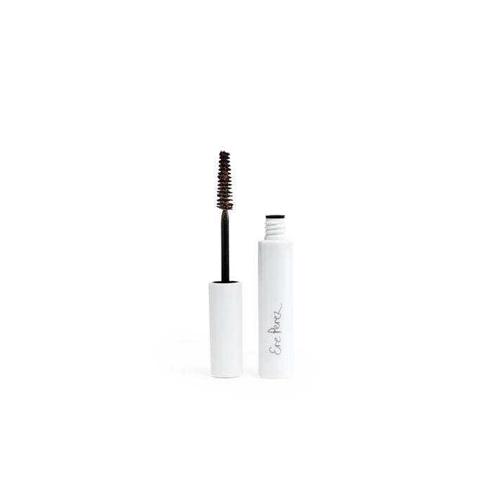 Open a white tube labeled in a handwritten style with Ere Perez branding to reveal the Natural Almond Mascara. It features a black wand and is infused with nourishing almond oil, providing smudge-proof wear for flawless lashes all day against a plain white backdrop.