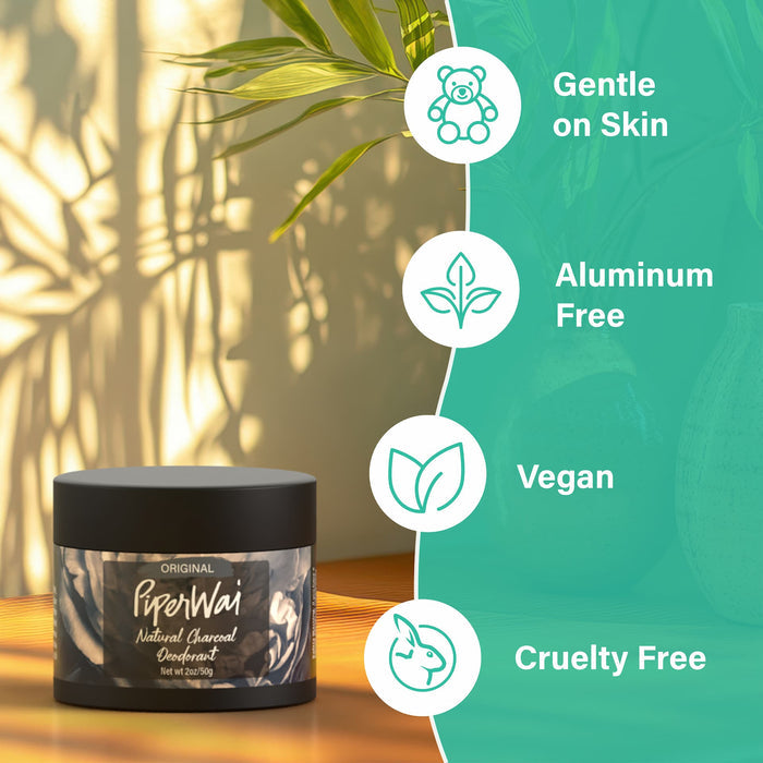 A jar of PiperWai Natural Deodorant Cream rests on a table, sunlight highlighting its activated charcoal formula and casting plant shadows nearby. Icons on the right emphasize features: gentle on skin, aluminum free, vegan, and cruelty free.
