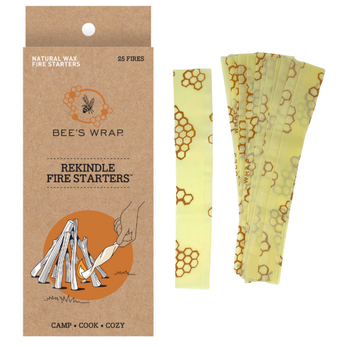 A box labeled Bees Wrap ReKindle - Fire Starters sits next to yellow, honeycomb-patterned fire starter strips; its illustration features a hand lighting a campfire, ideal for starting fires easily.