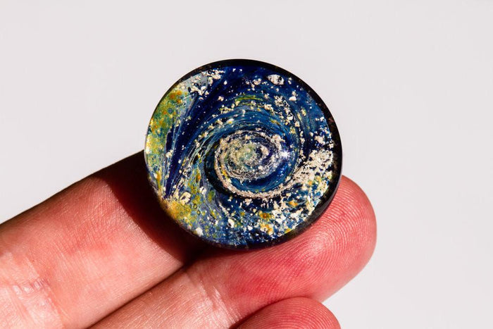 Flat blue galaxy worry stone infused with cremains for pocket carry