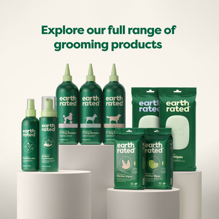 A variety of Earth Rated grooming products displayed on cylindrical podiums. The collection includes pet shampoo, deodorizer sprays, and wipes. Text above reads, "Explore our full range of grooming products.