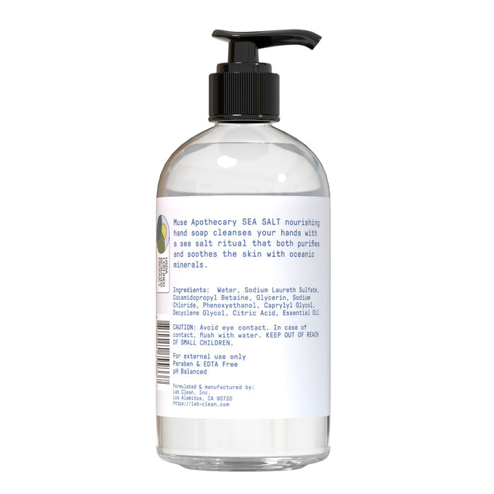 A clear pump bottle labeled Muse Apothecary Nourishing Hand Soap, featuring a white ingredients and usage label, holds transparent soap.