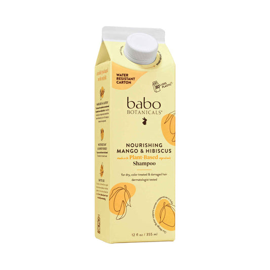 The Nourishing Shampoo for Dry, Damaged Hair by Babo Botanicals features vibrant yellow packaging with orange mango graphics and is enriched with mango butter. This 12 fl oz (355 ml) bottle provides sustainable care for dry, color-treated, or damaged hair.