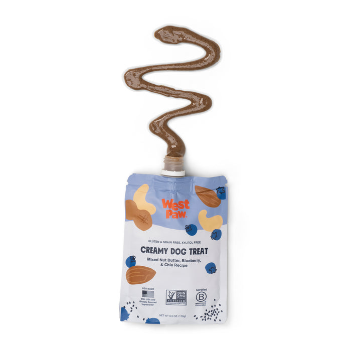The West Paw Nut Butter Blueberry Creamy Dog Treat packet features a zigzag of creamy brown treat, emphasizing plant-based nutrition with nut butters, blueberries, and chia for wholesome dog treats.