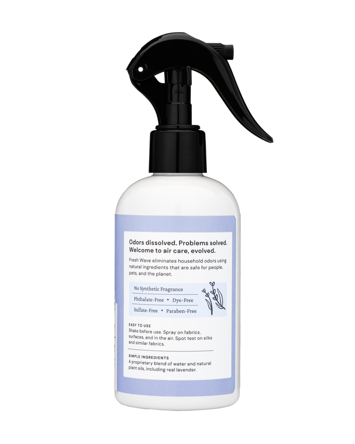 The Fresh Wave Odor Removing Fabric and Linen Spray features a black trigger nozzle for refreshing fabrics and rooms. The label states Welcome to air care, evolved, emphasizing its natural odor-removing formula, which is phthalate-free, dye-free, and paraben-free. Instructions and ingredients are on the label.