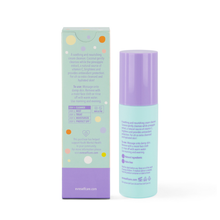 The evre. Oh So Extra Pineapple & Coconut Face Cleanser comes in a tall, cylindrical turquoise bottle with a lavender cap, featuring pineapple extract. It sits beside a colorful box adorned with text and pastel circle illustrations, labeled as a soothing cream cleanser.