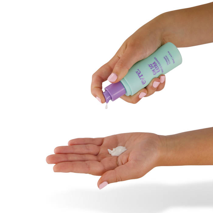 Against a pristine white background, someone dispenses Oh So Extra Pineapple & Coconut Face Cleanser by evre. from a pastel green and lavender tube into their open palm.