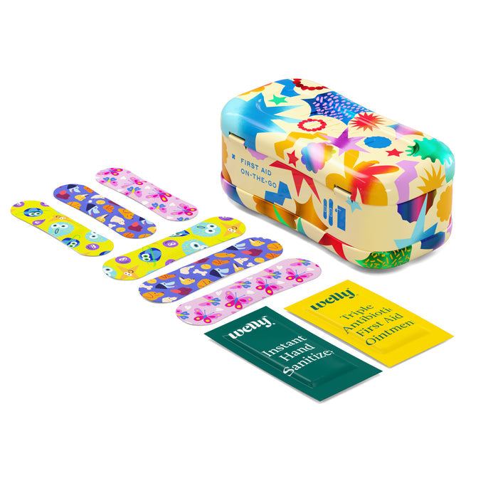 Welly’s On-The-Go First Aid Kit includes a floral tin, six assorted colorful patterned bandages, and two green-yellow wipes (Instant Hand Sanitizer and Antiseptic Towelettes for Children)—a cheerful first aid essential.