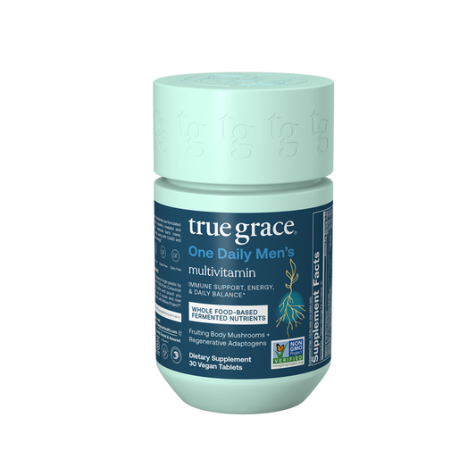 True Grace One Daily Mens Multivitamin comes in a teal bottle with a blue label, offering immune support, energy, and daily balance from chelated and fermented minerals plus an organic mushroom blend in 30 vegan tablets. Certification logos are included.