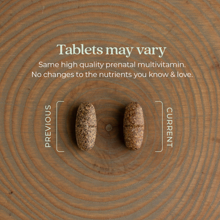 Two tablets on a textured wooden surface are shown side by side. The left tablet is slightly larger and labeled "Previous," while the right one is labeled "Current." Text above reads, "Tablets may vary. Same high quality prenatal multivitamin.