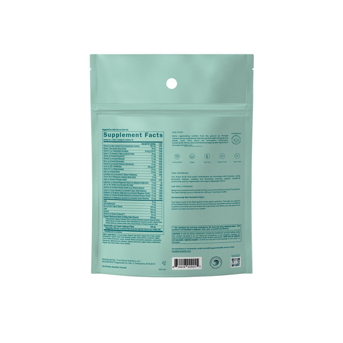 The teal pouch of the One Daily Womens 40+ Multivitamin Refill by True Grace displays detailed nutritional information with coenzyme B vitamins. It features a resealable zip at the top, a barcode at the bottom, and icons highlighting product features.