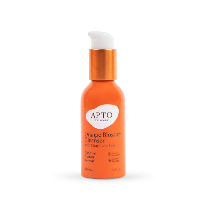 APTO Skincares Orange Blossom Cleanser with Grapeseed Oil is a 120 ml/4 fl. oz lightly foaming face wash in an orange bottle with a white pump, featuring natural fruit ingredients for clarifying, soothing, renewing effects and is cruelty-free.