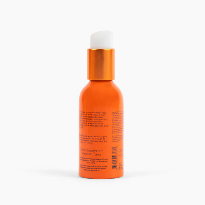 The image shows APTO Skincares Orange Blossom Cleanser with Grapeseed Oil, a lightly foaming face wash in an orange pump bottle on a white background. The minimalistic label highlights its natural fruit ingredients and cruelty-free formula, complemented by small text and a shiny cap.