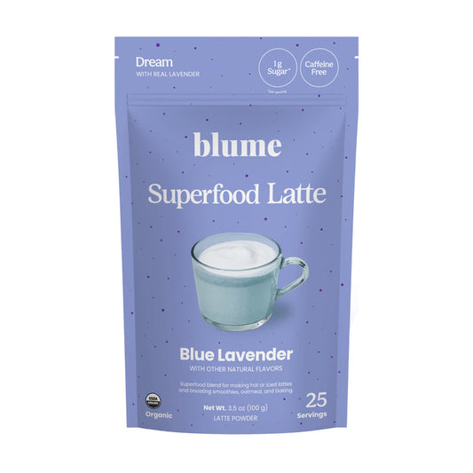 A light purple pouch labeled blume Organic Blue Lavender Latte Powder features a mug of frothy latte. This organic, caffeine-free blend provides 25 servings of a calming bedtime drink.