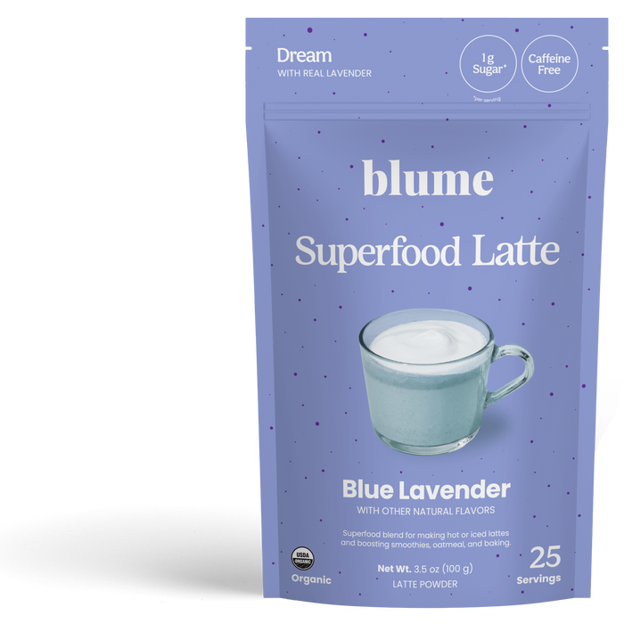 A blue bag of blume Organic Blue Lavender Latte Powder features a mug of latte on the front. This calming, caffeine-free drink has just 1g sugar per serving and provides 25 servings in each pack.