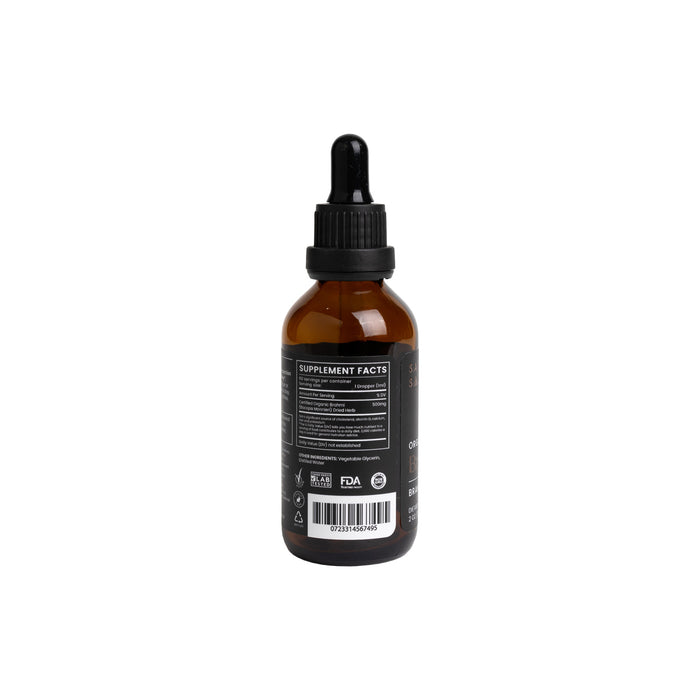 A brown glass dropper bottle with a black cap and pipette on a white background displays supplement facts, a barcode, and certifications for Sattva Souls Organic Brain Boost Tincture, an Ayurvedic Brahmi blend neuro-protective elixir.