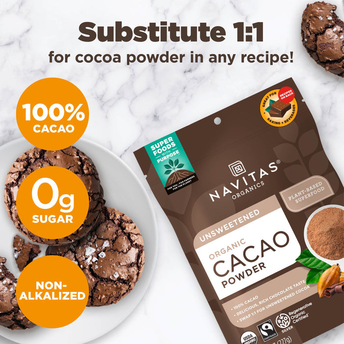 Package of Navitas Organics unsweetened organic cacao powder on a white surface with chocolate cookies. Text highlights 100% cacao, 0g sugar, non-alkalized, and suitability as a 1:1 cocoa powder substitute.