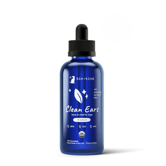 The Organic Clean Ears by kin+kind comes in a blue bottle with a dropper, providing an easy-to-use organic solution for dog ear care. This leave-in cleanser relieves odor, itch, and wax while featuring vet-formulated natural ingredients made in the USA.