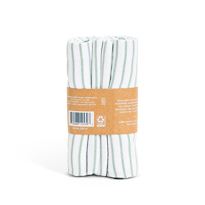 Grove Co.s Organic Cotton Striped Kitchen Towels, in vintage white and green, are quick-drying essentials made from organic cotton. They come rolled with a brown recyclable band featuring a barcode and care instructions.