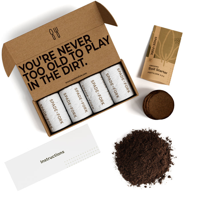 The gardening kit from Spade to Fork includes an open box with Youre never too old to play in the dirt text, coir pots, a packet of Organic Soil Starter Fertilizer 3.0, and organic potting soil (suitable for indoor or outdoor use), plus an instruction sheet under the Organic Indoor & Outdoor Potting Soil Multi-Pack.