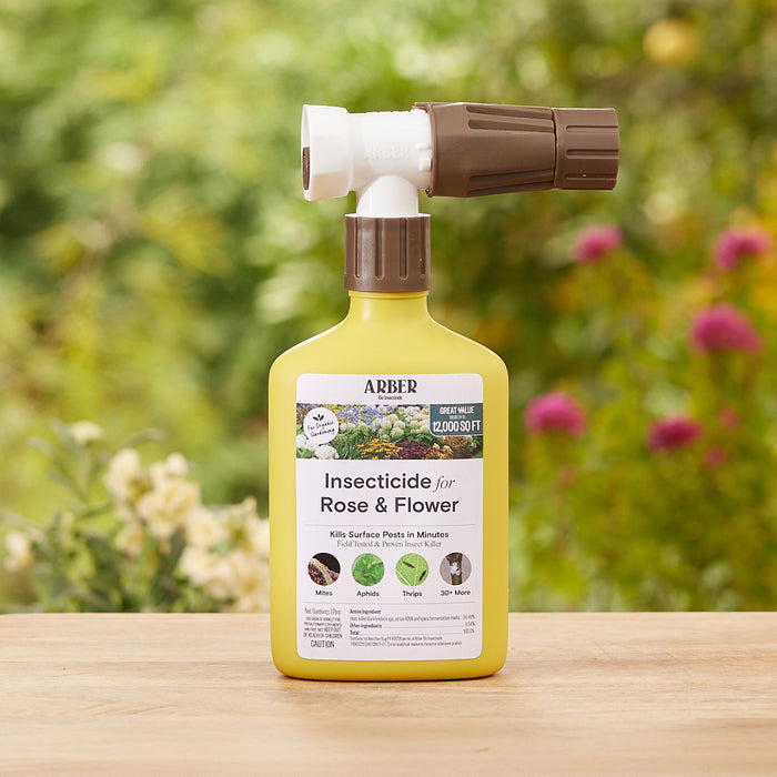 The Organic Insecticide for Rose and Flowers RTS from Arber includes a nozzle attachment, covers 2,000 sq. ft., and effectively targets pests like mites, aphids, and thrips. The label scene features blurred greenery with pink flowers.